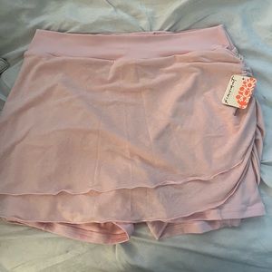 Pink mini tennis skirt with built in shorts. Size Large from Free People